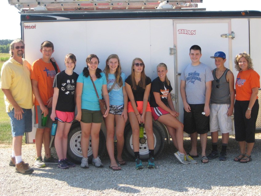 Youth group standing by trailer