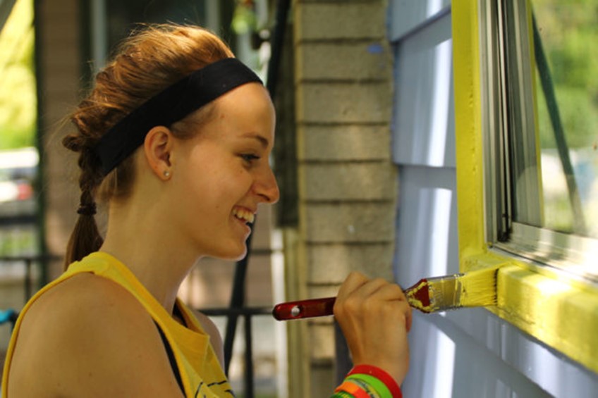 Girl Painting a house