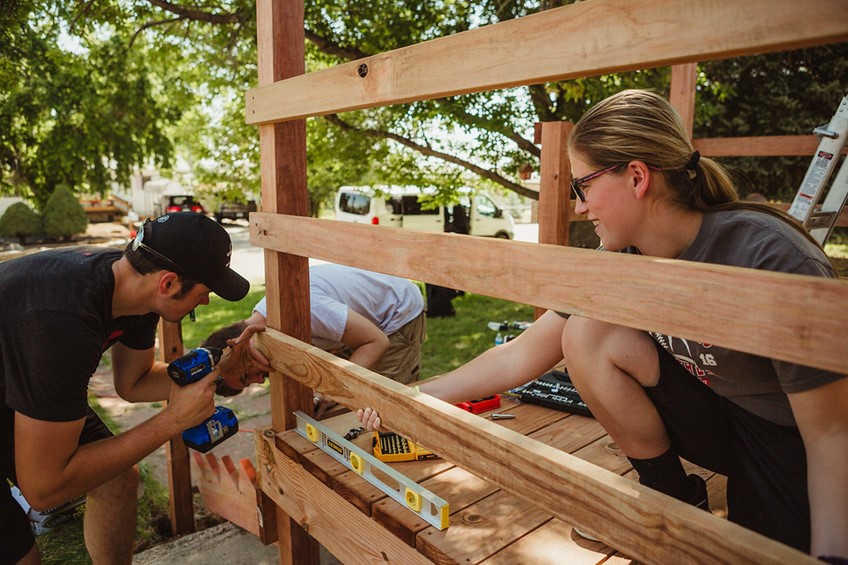 Workers happily working on a deck